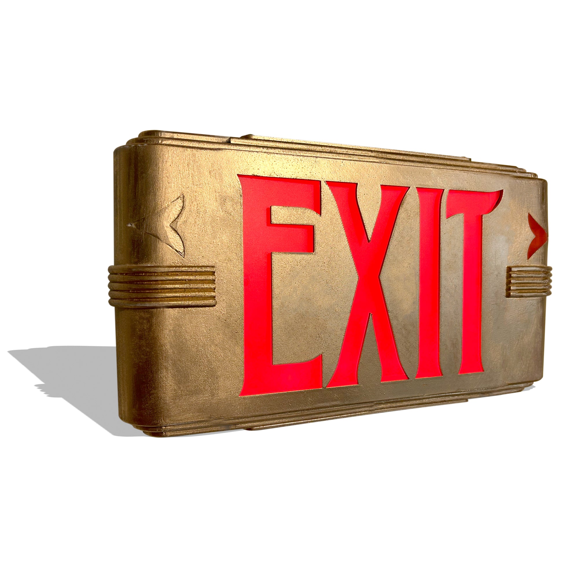 Gold Art Deco exit sign with red 'EXIT' text on a white background