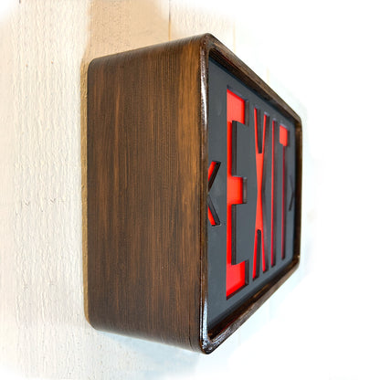 Eames inspired wooden frame with red and black 'EXIT' sign on a white wall